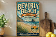 A vintage-style metal sign for Beverly Beach State Park in Oregon, featuring a beach scene with a large rock formation and a sunset.