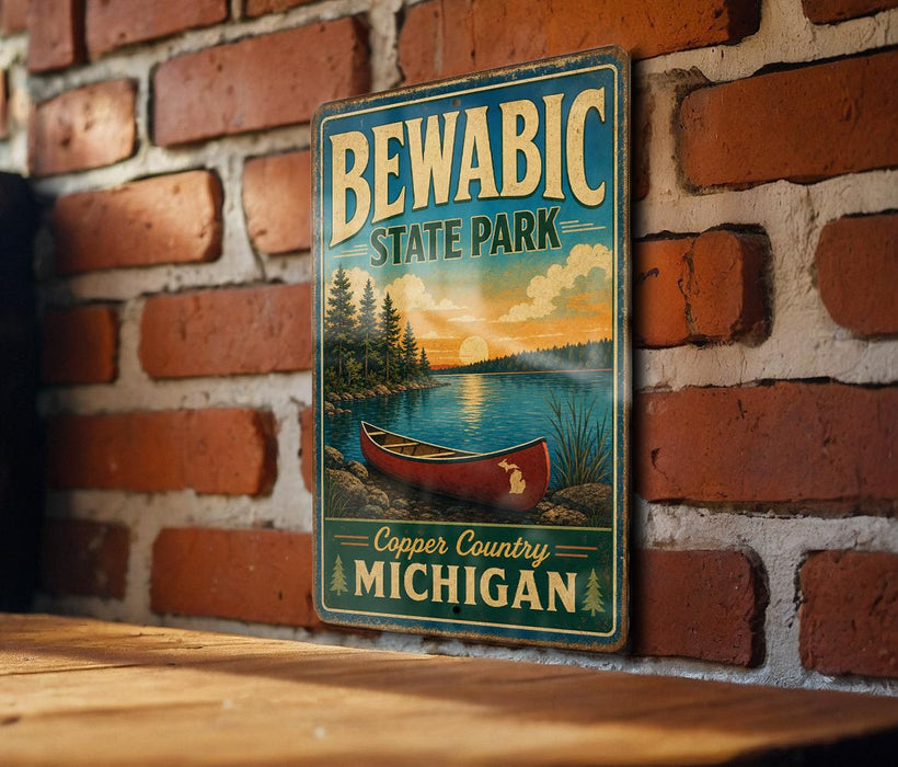 A vintage metal sign for Bewabic State Park, featuring a canoe and a scenic landscape, is displayed on a brick wall.