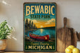 A vintage-style sign for Bewabic State Park, featuring a red canoe on a lake with a sunset in the background.
