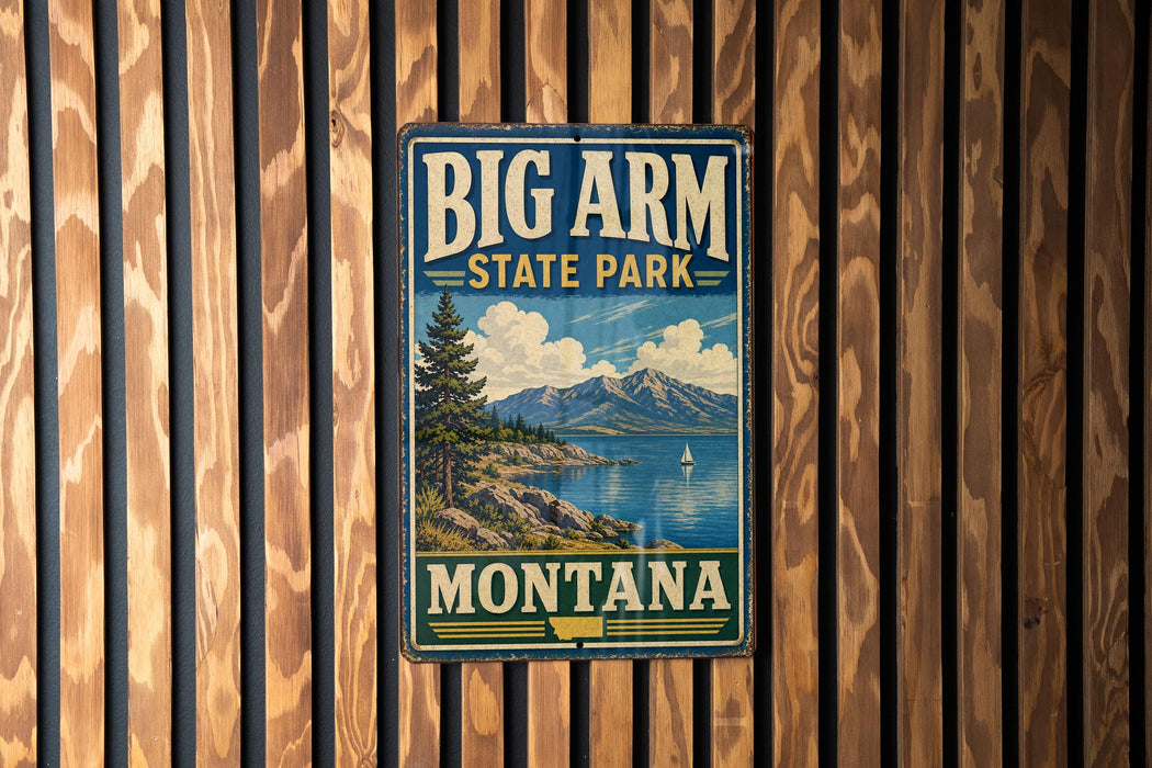 A vintage metal sign for Big Arm State Park in Montana, featuring a scenic landscape with mountains, a lake, and a pine tree.