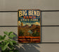 A vintage-style metal sign for Big Bend Ranch State Park in Texas, featuring a desert landscape with mountains, cacti, and a river.
