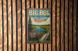 A vintage-style metal sign for the Big Bog State Recreation Area in Minnesota, featuring a scenic landscape with a wooden walkway and a pine tree.