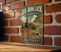 a vintage-style sign for the Big Bone Lick State Historic Site in Kentucky, with an illustration of a dinosaur and other prehistoric creatures.