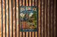 A vintage metal sign advertising the Big Bone Lick State Historic Site in Kentucky, featuring an illustration of a large elephant and a bear.