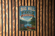 A vintage-style metal sign for Big Hill Pond State Park in Tennessee, featuring a scenic image of a lake and a canoe.
