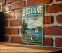 A vintage-style metal sign for Big Lake State Park in Missouri, featuring a sailboat on a lake and a scenic landscape.