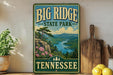 A vintage-style sign for Big Ridge State Park in Tennessee, featuring a scenic landscape with mountains, a river, and pine trees.