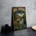 A vintage-style metal sign for Big Spring State Park in Pennsylvania, featuring a scenic illustration of a waterfall and a building.