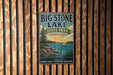 A vintage-style metal sign for Big Stone Lake State Park in Minnesota, featuring a scenic illustration of a lake, mountains, and a sailboat.