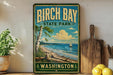 A vintage-style sign for Birch Bay State Park in Washington, featuring a scenic image of the bay with a sailboat and a tree.