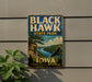 A vintage-style sign for Black Hawk State Park in Iowa, featuring a scenic landscape with a cliff, river, and bird in flight.