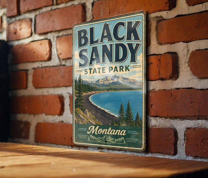 A vintage-style metal sign for Black Sandy State Park in Montana, featuring a scenic landscape with mountains, pine trees, and a lake.