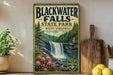 A vintage-style sign for Blackwater Falls State Park in West Virginia, featuring a waterfall surrounded by pine trees and pink flowers.