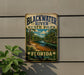 A vintage-style sign for Blackwater River State Park in Florida, featuring a scenic image of the river surrounded by lush greenery.