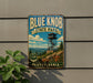 A vintage-style metal sign for Blue Knob State Park in Pennsylvania, featuring a scenic image of the park's lookout tower and surrounding landscape.