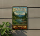 A vintage-style metal sign for Bogachiel State Park in Washington, featuring a scenic landscape with mountains, pine trees, and a river.