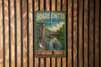 A vintage-style metal sign for Bogue Chitto State Park in Louisiana, featuring a scenic illustration of a person in a canoe on a river surrounded by lush greenery.