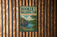 A vintage-style metal sign for Booker T. Washington State Park in Tennessee, featuring a scenic landscape with a river and bridge.