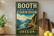 A vintage-style sign for the Booth State Scenic Corridor in Oregon, featuring a scenic mountain landscape with a winding road.