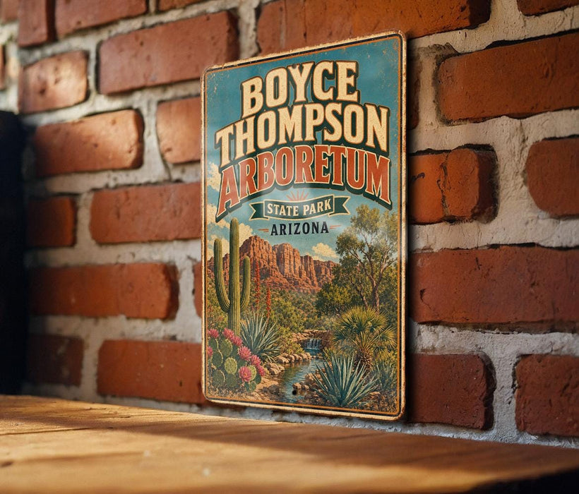 A vintage metal sign for Boyce Thompson Arboretum in Arizona, featuring a desert landscape with cacti and other desert plants.