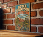 A vintage metal sign for Boyce Thompson Arboretum in Arizona, featuring a desert landscape with cacti and other desert plants.