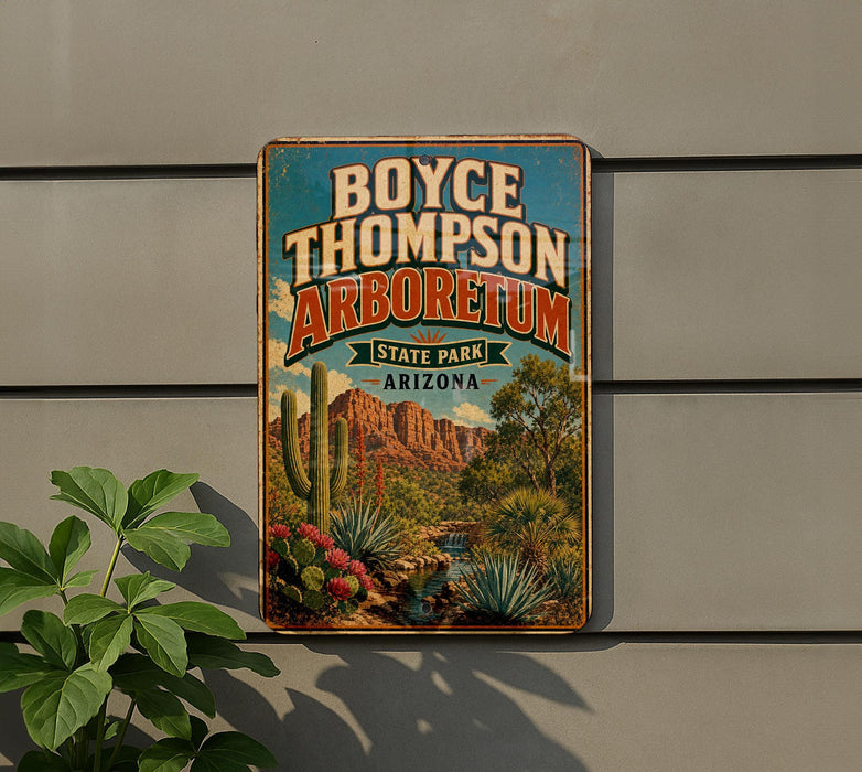 A vintage-style metal sign for Boyce Thompson Arboretum in Arizona, featuring a desert landscape with cacti and other desert plants.