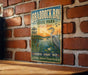 A vintage-style metal sign for Braddock Bay State Park in New York, featuring an illustration of a crane and a lake at sunset.