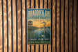 A vintage metal sign for Braddock Bay State Park in New York, featuring a scenic illustration of a bird and a wooden structure.