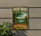 A vintage-style sign for Brentwood State Park, featuring a scenic landscape with a lake, trees, and a picnic table.