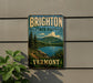 A vintage-style sign for Brighton State Park in Vermont, featuring a scenic landscape with mountains, trees, and a lake.