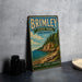 A vintage-style metal sign for Brimley State Park in Michigan, featuring a scenic landscape with a beach, cliffs, and pine trees.