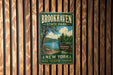 A vintage metal sign for Brookhaven State Park, featuring a scenic image of the park and its surroundings.