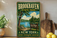 A vintage-style metal sign for Brookhaven State Park in New York, featuring a scenic landscape with a lake and trees.