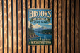 A vintage metal sign for Brooks Memorial State Park in Washington, featuring a scenic landscape with a mountain and a river.