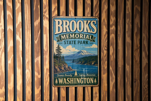 A vintage metal sign for Brooks Memorial State Park in Washington, featuring a scenic landscape with a mountain and a river.