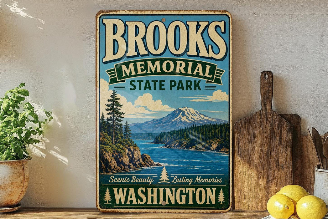 A vintage-style sign for Brooks Memorial State Park in Washington, featuring a scenic mountain landscape and a pine tree.