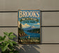 A vintage-style metal sign for Brooks Memorial State Park in Washington, featuring a scenic landscape with mountains, forests, and a lake.