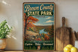 A vintage-style sign for Brown County State Park in Indiana, featuring a scenic landscape with a river and autumn foliage.