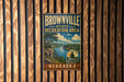A vintage metal sign for the Brownville State Recreation Area in Nebraska, featuring a scenic landscape with a river and mountains.