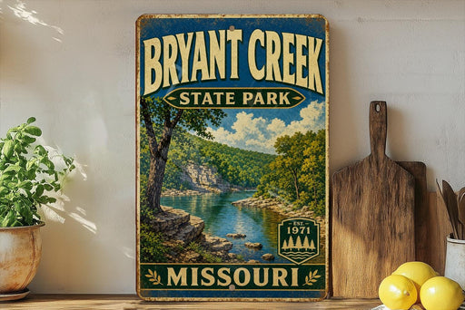A vintage-style sign for Bryant Creek State Park in Missouri, featuring a scenic landscape with a river and trees.