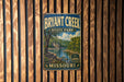 A vintage metal sign for Bryant Creek State Park in Missouri, featuring a scenic landscape with a river and forest.