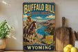 A vintage-style sign for Buffalo Bill State Park in Wyoming, featuring a cowboy on horseback in a scenic landscape.
