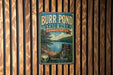 A vintage metal sign for Burr Pond State Park in Connecticut, featuring a scenic landscape with a lake and mountains.