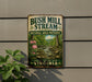 A vintage-style metal sign with the text "Bush Mill Stream Natural Area Preserve" and "Protect, Explore, Enjoy Virginia" is displayed on a wall, with a plant to the left.