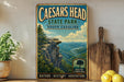a vintage-style metal sign for Caesars Head State Park in South Carolina, with a scenic mountain landscape and a palm tree. The sign is displayed on a shelf next to a wooden cutting board and a potted plant.