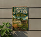 A vintage metal sign for Cambridge Junction Historic State Park in Michigan, featuring an illustration of a historic building and a signpost.