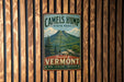 A vintage metal sign for Camelsump State Park, featuring a mountain landscape and the text "Beautiful Vermont" and "Hike * Explore * Discover".