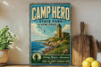 a vintage-style sign for Camp Hero State Park in New York, with a lighthouse and a coastal landscape in the background.