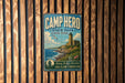 A vintage-style metal sign for Camp Hero State Park in New York, featuring a lighthouse and a coastal landscape.