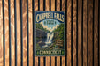 A vintage metal sign for Campbell Falls State Park in Connecticut, featuring a waterfall and forest scenery.